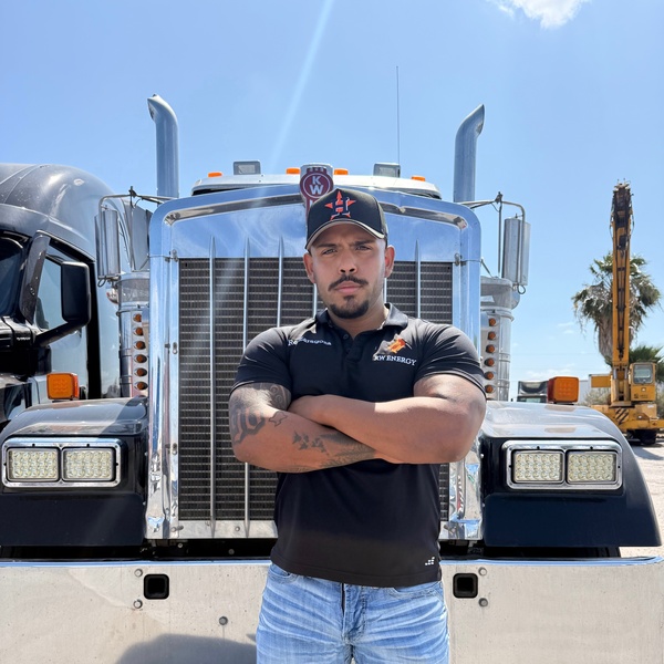 Rey Zaragoza, founder of Real World Freight, standing in front of a Kenworth truck